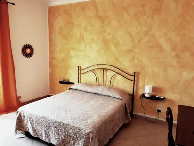 a bedroom with a bed in a room at Granello di Sabbia in San Vito lo Capo