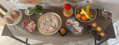 a table with different types of food on it at Granello di Sabbia in San Vito lo Capo