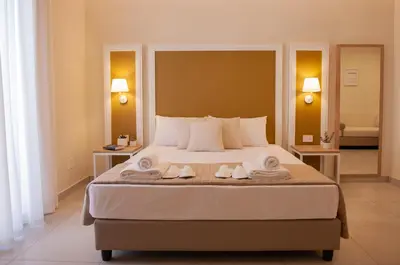 a bedroom with a large bed with towels on it at Balestrate Center Rooms in Balestrate