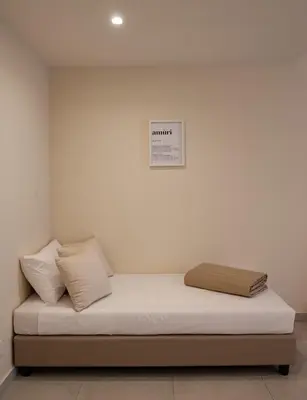 a bed with two pillows and a picture on the wall at Balestrate Center Rooms in Balestrate