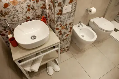 a bathroom with a sink and a toilet at Balestrate Center Rooms in Balestrate