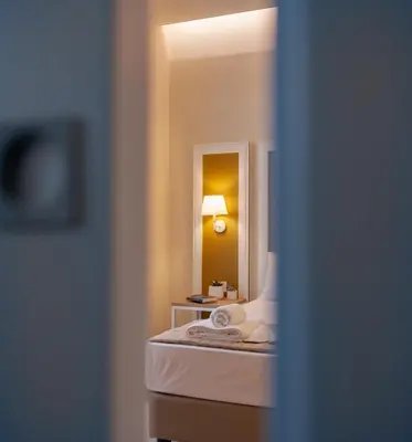 a hotel room with a bed and a mirror at Balestrate Center Rooms in Balestrate