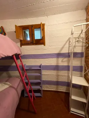 a room with two bunk beds and a window at Holiday Green in Carini