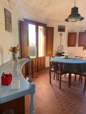 a living room with a table and a dining room at Holiday Green in Carini