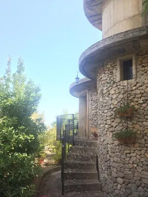 a stone building with stairs leading up to it at Holiday Green in Carini