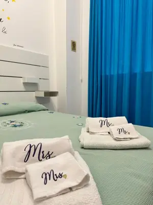 a bedroom with two beds with mris towels on them at mamali in Terrasini