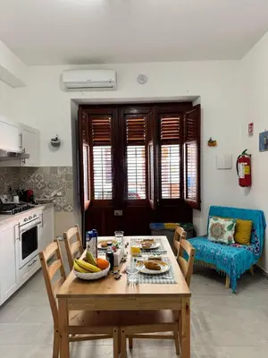 a kitchen with a table with a bowl of fruit on it at mamali in Terrasini