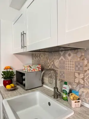 a kitchen counter with a sink and a microwave at mamali in Terrasini