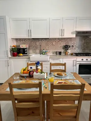 a kitchen with a wooden table with food on it at mamali in Terrasini