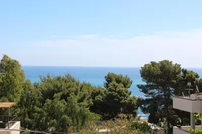 a view of the ocean from a house at Appartanvilla Magellano in Mondello