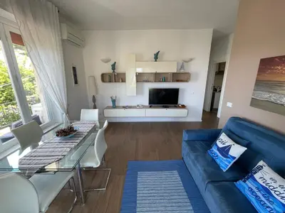 a living room with a blue couch and a tv at Appartanvilla Magellano in Mondello