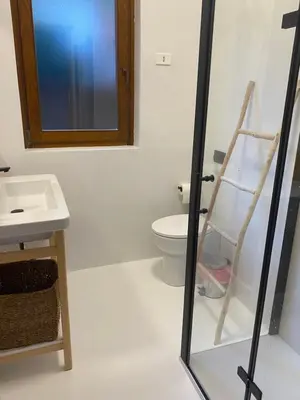 a bathroom with a sink and a toilet and a window at Torre delle mandre in Altavilla Milicia