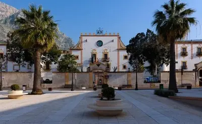 a large building with palm trees in front of it at Da Turiddu in Cinisi