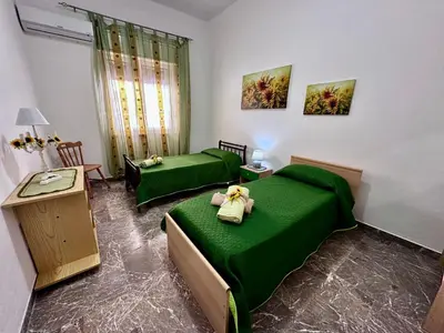 a room with two green beds in a room at Da Turiddu in Cinisi
