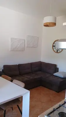 a living room with a couch and a table at I Giardini del mare casa vacanza in Buonfornello