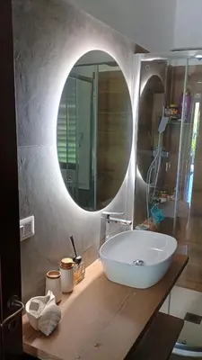 a bathroom with a white sink and a mirror at I Giardini del mare casa vacanza in Buonfornello