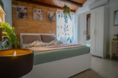 a room with a bed with a candle in it at La Casetta di Dandrì in Monreale