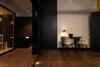 a dining room with a table and two chairs at Black Room Suite and SPA in Carini