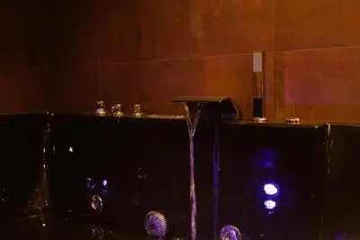 a water fountain in a room with a counter at Black Room Suite and SPA in Carini