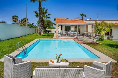 a swimming pool in the backyard of a house at Oasi delle Nereidi in Alcamo