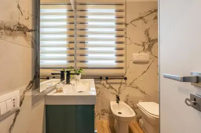 a bathroom with a sink and a toilet and a mirror at Villetta Golfo di Macari 10min San Vito Lo Capo - Horizonte Selections in Castelluzzo