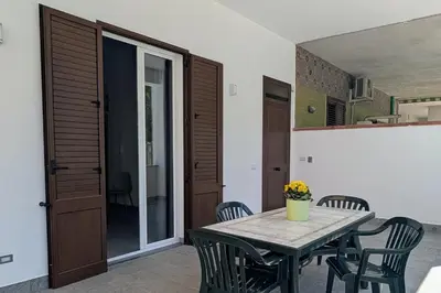 a dining room with a table and chairs at Nonna Rosa Anna in Isola delle Femmine