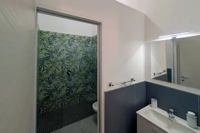 a bathroom with a shower with a glass door at Nonna Rosa Anna in Isola delle Femmine