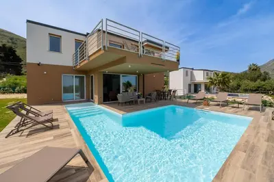 a villa with a swimming pool in front of a house at Villa Soho in Castellammare del Golfo