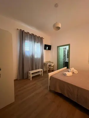a bedroom with a bed and a table and a mirror at MGrooms in Palermo