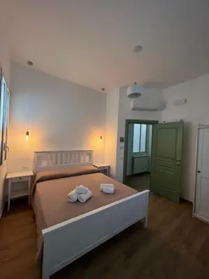 a bedroom with a bed with two towels on it at MGrooms in Palermo