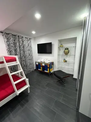 a bedroom with a bunk bed and a television at Maisondedesign in Palermo