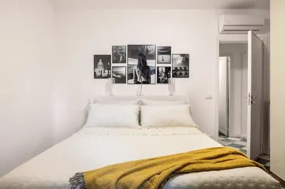 a bedroom with a bed with three pictures on the wall at Colonne San Domenico in Palermo