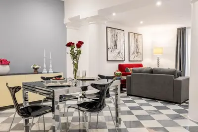 a living room with a glass table and chairs at Colonne San Domenico in Palermo