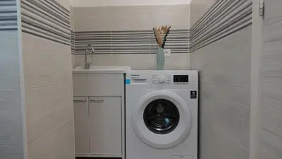 a laundry room with a washing machine and a sink at Stella di mare Acquamarine in Balestrate