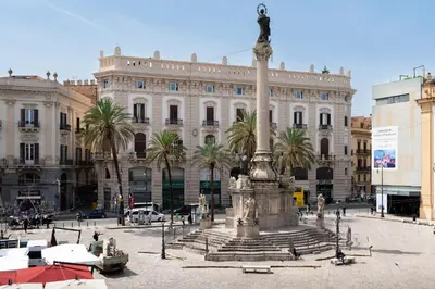 a large fountain in front of a building at Piano Imperiale Home in Palermo