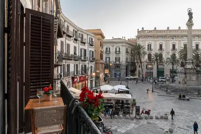 a view from a balcony of a city street with buildings at Piano Imperiale Home in Palermo