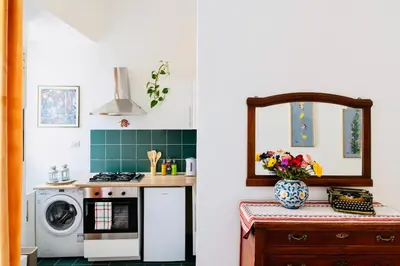 a kitchen with a washing machine and a sink at Piano Imperiale Home in Palermo