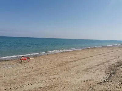 a couple of people sitting on the beach at Borgomare in Campofelice di Roccella