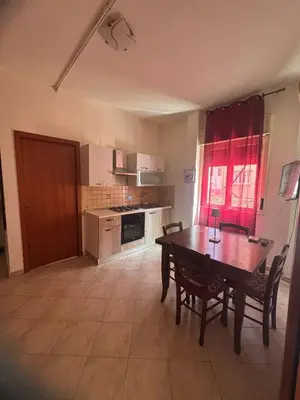 a kitchen with a table and chairs in a room at Al Politeama casa vacanze in Palermo