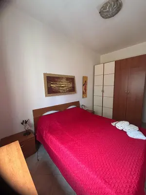 a bedroom with a red bed with towels on it at Al Politeama casa vacanze in Palermo