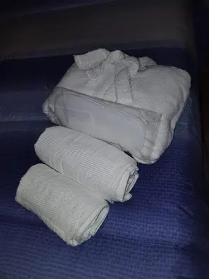 a pile of folded towels on a blue blanket at Casa Frufa in Terrasini