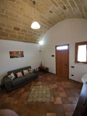 a living room with a couch and a brick ceiling at Casa Frufa in Terrasini