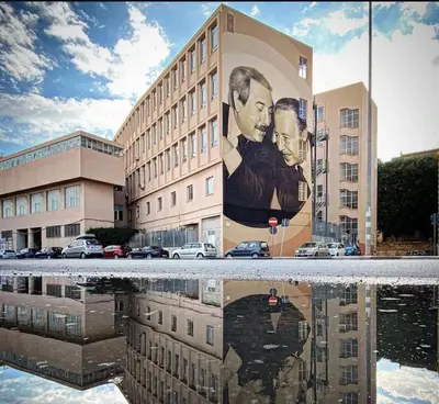 a building with a painting of two men on it at Manuè's House in Palermo