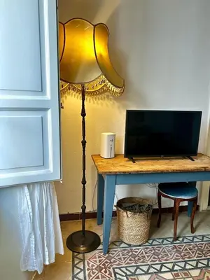 a desk with a laptop computer on top of a lamp at Casa Mediterraneo in Palermo
