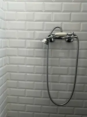 a shower head hanging on a brick wall at Casa Mediterraneo in Palermo