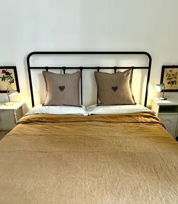 a large bed with two pillows on top of it at Casa Mediterraneo in Palermo