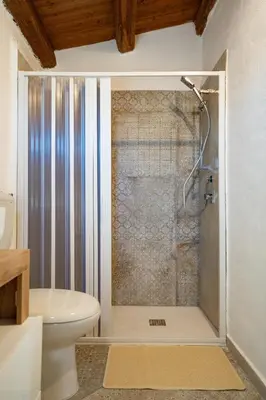 a bathroom with a shower and a toilet at Rooms Parrinelli in Partinico