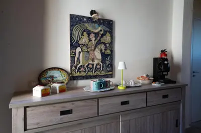 a wooden dresser in a room with a painting on the wall at Rooms Parrinelli in Partinico