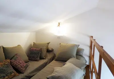 a living room with a couch with pillows at Casa panorama in Castelluzzo