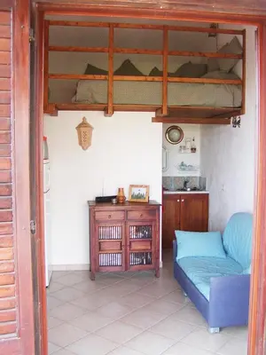 a living room with a couch and a bunk bed at Casa panorama in Castelluzzo